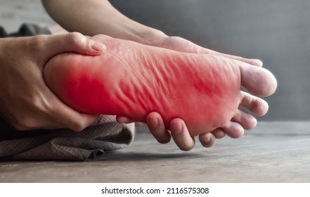 Tingling and burning sensation in foot of Asian young man with diabetes. Foot pain. Sensory neuropathy problems. Foot nerves problems. Plantar fasciitis. - Shutterstock ID 2116575308