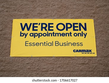 Tinley Park, IL, US – April 16th 2020: CarMax Parking Lot: CarMax Posted Sign Depicting “We”re Open By Appointment Only – Essential Business.” CarMax Seeking To Combat The Spread Of Covid-19.       