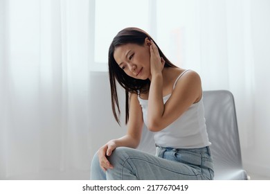 Tinnitus Otitis Meningitis Hearing Loss. Upset suffering tanned beautiful young Asian woman holding aching ear at home interior living room. Injuries Poor health Illness concept. Cool offer Banner - Shutterstock ID 2177670419