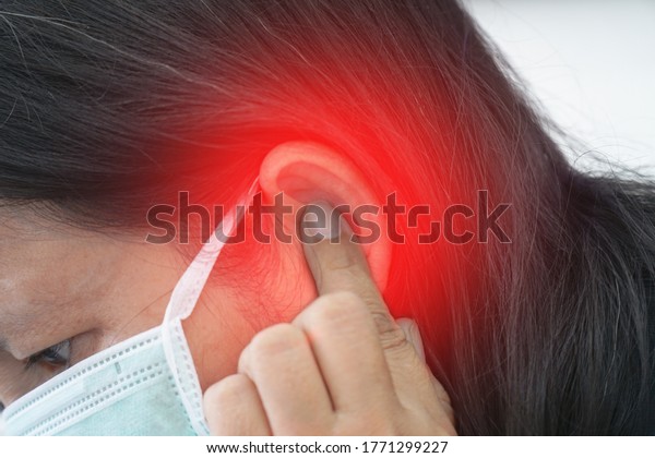 Tinnitus.female\
having ear pain touching painful\
head.