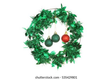 Tinsel Holly Christmas Wreath With Red And Green Glitter Baubles Isolated Against White