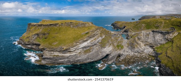 Tintagel Castle Bridge. Tintagel bay panoramic aerial view in Cornwall, United Kingdom. British west landscape coastline for summer holidays with green rocky cliffs on the Atlantic Ocean.  - Powered by Shutterstock