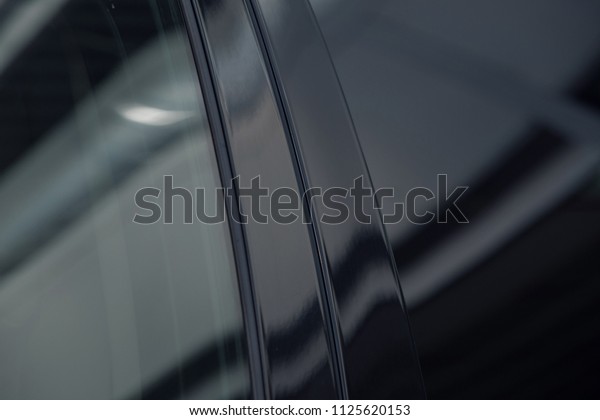 tinted\
black car Windows that reflect the glass\
ceiling