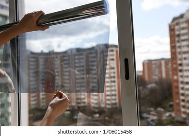 Tinted Glass In The House. Window Dimming By Dark Film. Tinting Home Window. Tint Film On The Background Of Multi-storey Buildings. Window View Through Tinted Glass