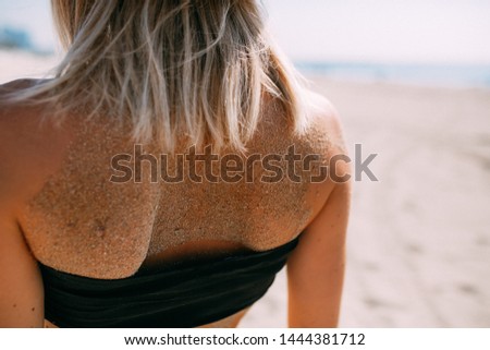 Tiny Beautiful girl having nice day at the beach with watrmelon and in fashion swimsuit