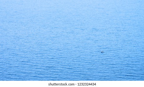 a tiny boat in the middle of the ocean