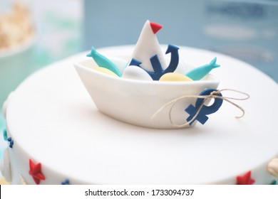 Tiny boat ship made out of fondant sugar candy. Homemade birthday cake decoration. Cute nautical theme aesthetic decoration ideas for kids happy celebrations.