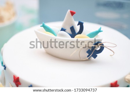 Tiny boat ship made out of fondant sugar candy. Homemade birthday cake decoration. Cute nautical theme aesthetic decoration ideas for kids happy celebrations.