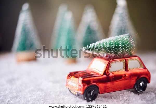Tiny car toy with christmas tree. Christmas\
preparation concept