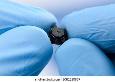 Tiny Cell Phone Camera Module In Hands. Camera Sensor Technology Research.