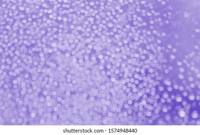 tiny circle bokeh lights with purple background.