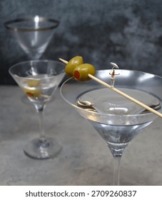 A Tiny Circus Performer walks across a Gin Martini Toothpick.