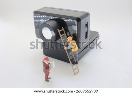 Tiny construction workers fix and inspect a large computer disk drive