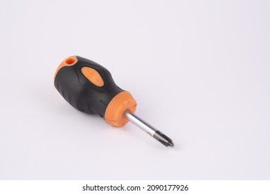 Tiny crosshead screwdriver with a plastic orange handle, isolated over the white background