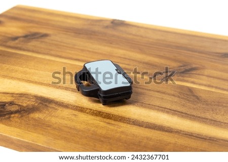Tiny doll sized sandwich toaster on a wood cutting board closed