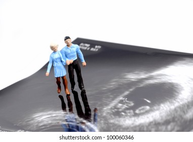 Tiny Figure Of Couple Walking On Early Pregnancy Ultrasound Image