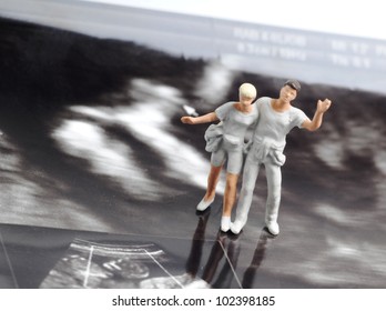 Tiny Figure Of Couple Walking On Early Pregnancy Ultrasound Image