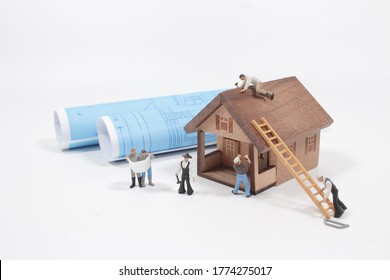 tiny figure of worker at blue map. Rolls, housing.