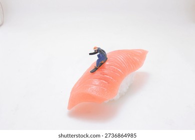 Tiny figurine glides along smooth pink seafood surface