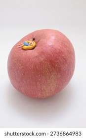 Tiny figurine lies floating ring on curved fruit