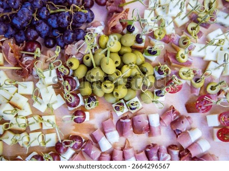 Tiny food with toothpick ham, olive and cheese
