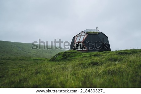Tiny geometric igloo homes with grass roofs on the hills. Most original houses and eco friendly in the world. Tourist popular attraction destination in Faroe Islands