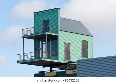 Tiny House At The Top Of A Bigger Building