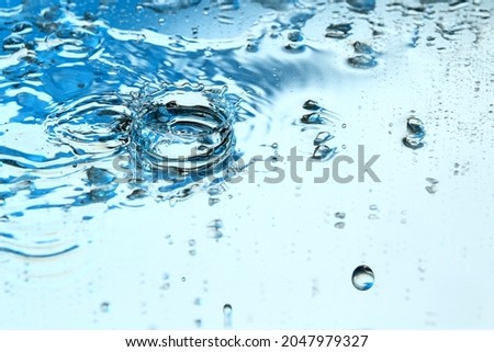 Tiny ice particle on wet surface