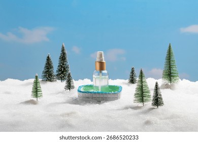 A tiny, inviting pool rests in a blanket of snow, framed by miniature festive pine trees. The detail of a plastic spray bottle floating within the pool adds a modern, almost surreal touch
