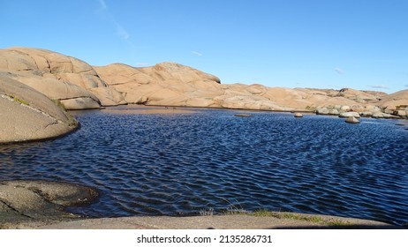 Tiny lake between massive rocks.