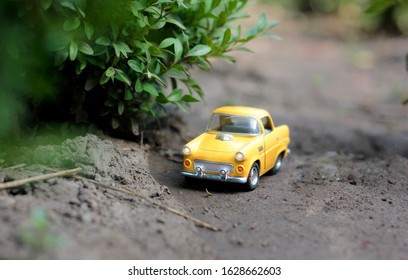 A tiny lightweight yellow car 