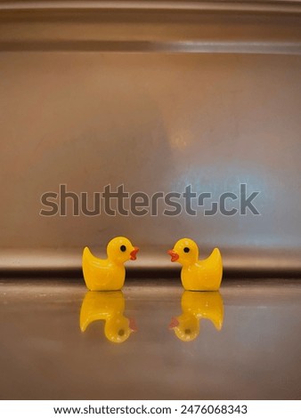 Tiny little plastic ducks staring at each other
