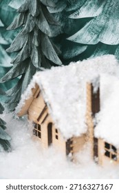 A tiny log cabin with snow on it.