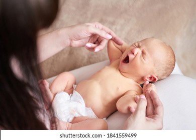 Tiny newborn. Mother touch little people. Healthcare massage concept. Modern parenthood. Comfort and safety sleep on knees. Human insurance. Family miracle. Closed eyes and yawn