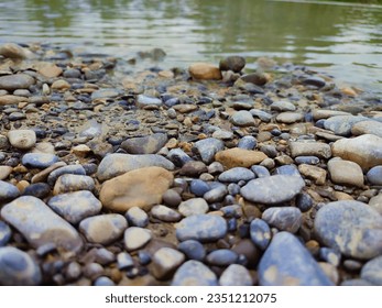 Tiny pebbles line the river's edge, creating a delicate mosaic of nature's artistry.