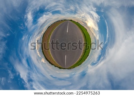 tiny planet in blue overcast sky with beautiful clouds with transformation of spherical panorama 360 degrees. Spherical abstract aerial view. Curvature of space.
