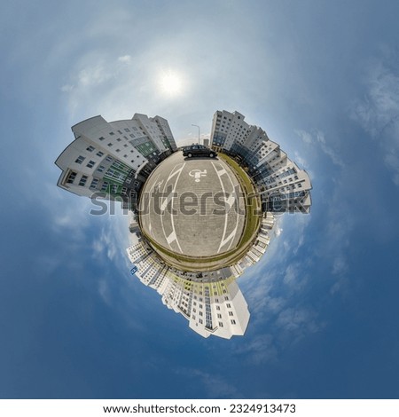 tiny planet in blue sky with clouds in city center near modern skyscrapers in residential complex. Transformation of spherical 360 panorama in abstract aerial view.