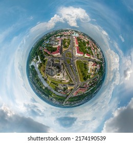 tiny planet in sky with clouds overlooking old town, urban development, historic buildings, crossroads with bridge across wide river. Transformation of spherical 360 panorama in abstract aerial view.
