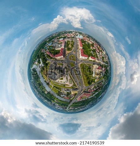 tiny planet in sky with clouds overlooking old town, urban development, historic buildings, crossroads with bridge across wide river. Transformation of spherical 360 panorama in abstract aerial view.