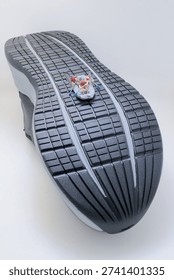 Tiny rafting team rows vigorously across textured sneaker surface