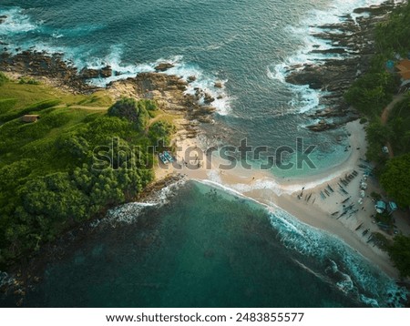 A tiny sand beach spit between the green paradise peninsula and tropical coastline of Sri Lanka