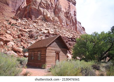 The Tiny Small Fruita Schoolhouse With The Red Rock Cliff On The Back In Utah