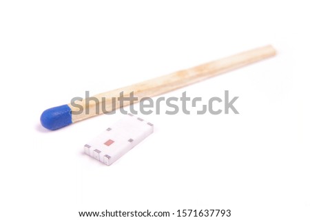 Tiny SMD chip antenna for wireless comunication in comparison with match head isolated on the white background
