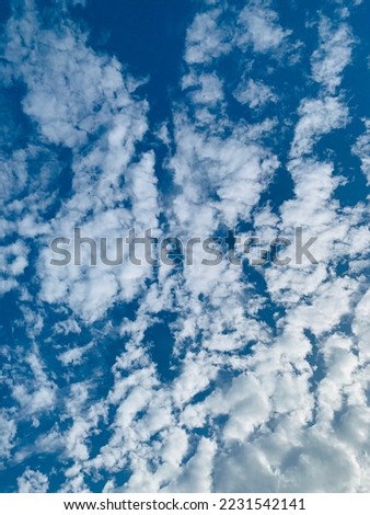 Tiny streaks of altocumulus clouds fill the beautiful sky. They often appear between lower stratus clouds and higher cirrus clouds at Bangkok, Thailand.no focus