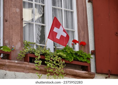 Tiny Swiss Flag in Window Flowerbed