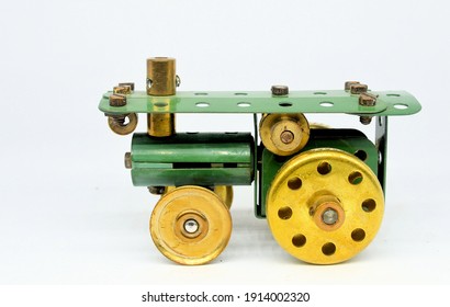 A tiny toy model of a traction engine made from a few small vintage Meccano constructional system parts on a white background.