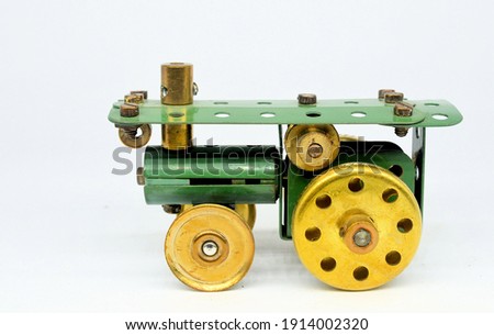 A tiny toy model of a traction engine made from a few small vintage Meccano constructional system parts on a white background.