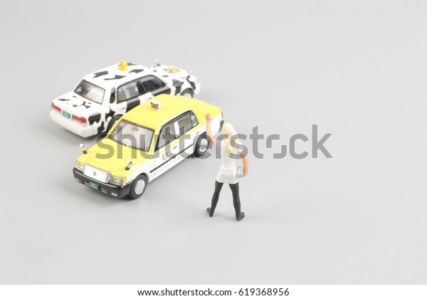 tiny of toy taxi
with the traveler figure