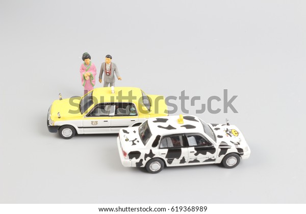 tiny of toy taxi
with the traveler figure