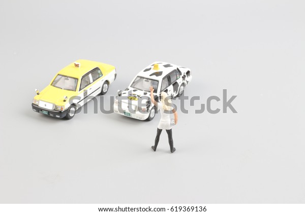 tiny of toy taxi\
with the traveler figure
